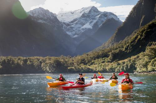 Kayakers in Milford Sound with Pembroke Glacier in the background