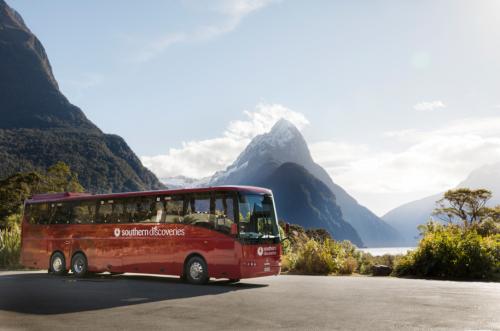 Milford Sound Coach in Milford Sound with Mitre Peak background