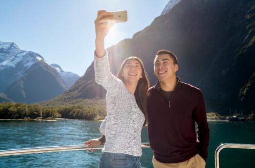 Milford Sound Scenic Cruise couple taking selfie
